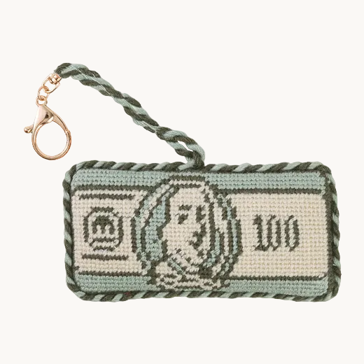 $100 bill needlepoint bag charm with green and white rope trim and gold-tone lobster clasp on white background