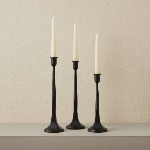 Set of 3 graduated black cast iron taper candle holders on a cream background — The Red Hound Gifts