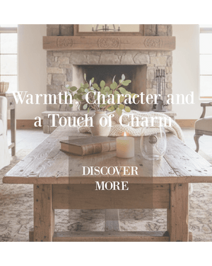 Cozy living room scene with wooden table, fireplace, and text overlay about warmth and character featuring The Red Hound Gifts Jubilee Stemless Wine Glass