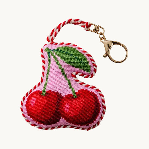Cherries needlepoint bag charm with red and white braided edge and gold tone lobster clip — retro fruit bag charm from The Red Hound Gifts