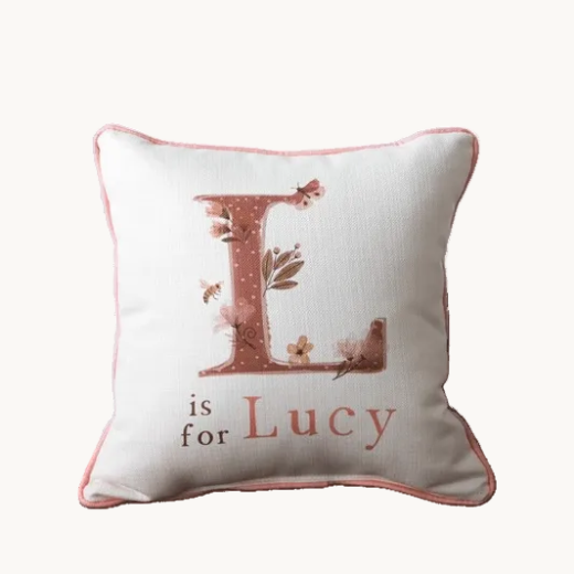 Personalized initial pillow on floral bedding