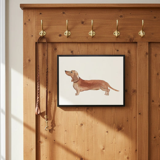 A framed watercolor art print of a dachshund dog in profile, featuring a light brown dog on an off-white background with a thin black frame.