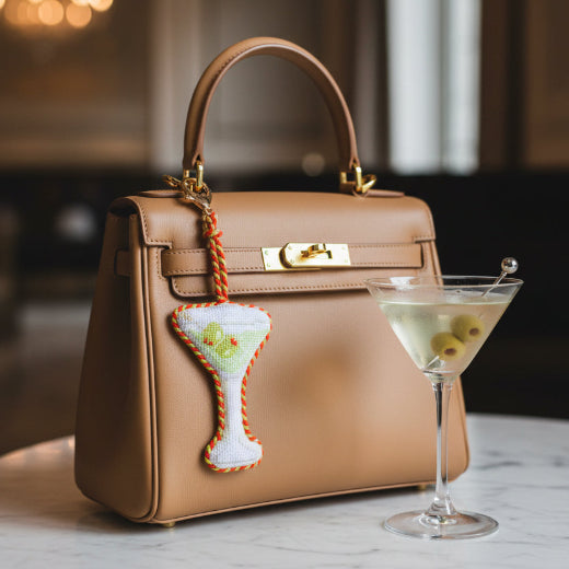 Needlepoint dirty martini glass bag charm in white and green with red and orange rope trim and gold tone clasp