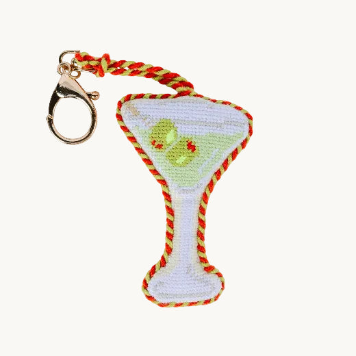 Needlepoint dirty martini glass bag charm in white and green with red and orange rope trim and gold tone clasp