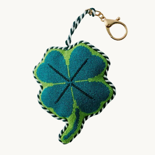 Needlepoint four leaf clover bag charm in teal and green plaid with gold-tone lobster clasp and twisted rope trim
