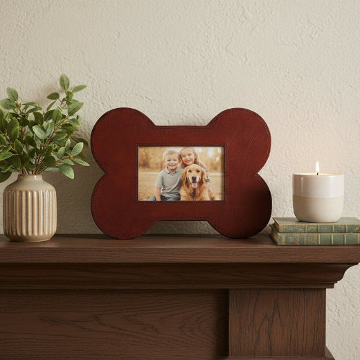 Brown leather bone-shaped 4x6 picture frame shown with a black Labrador photo. 