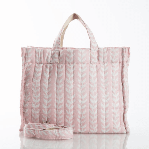 Pink tote bag with white pattern on a white background.