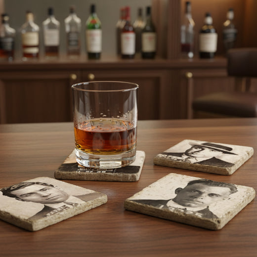 Four individual designer Italian tumbled marble table coasters featuring vintage mugshot portraits of Lucky Luciano, Al Capone, Frank Sinatra, and John Dillinger arranged in a grid.