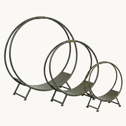 Three-piece black iron hoop log holders for fireplace wood storage, shown unnested from largest to smallest size on an isolated light backdrop.