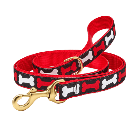 Dog leash with red and white bone pattern on a black background