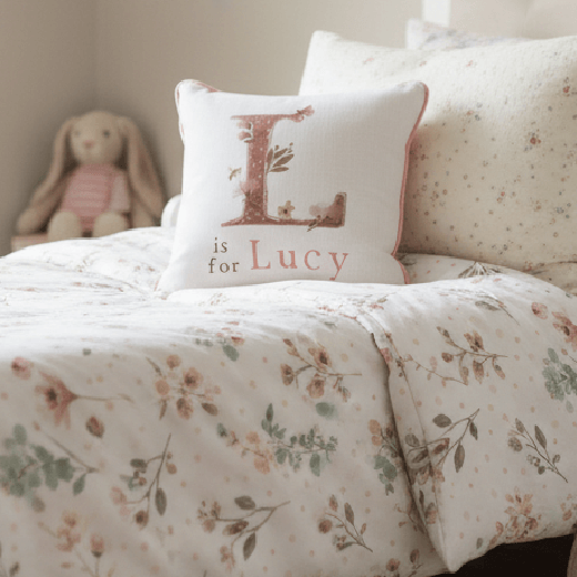Personalized initial pillow on floral bedding