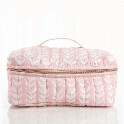 Pink quilted cotton train case with white leaf pattern on a white background