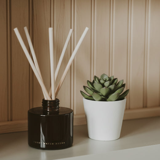 Pumpkin Spice reed diffuser in amber glass jar with dark brown gift box and natural rattan reeds. The Red Hound Gifts.