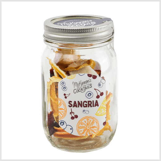 Mason jar with sangria ingredients and a label on a white background