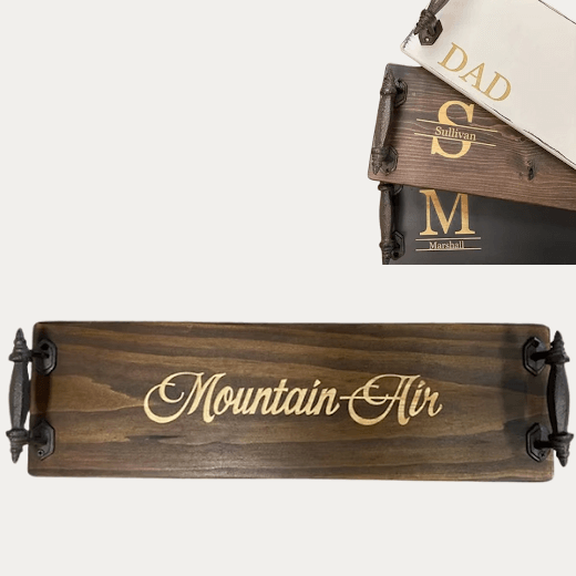 Personalized engraved wooden charcuterie tray with Logan script styled with cheese, grapes, and charcuterie on a marble kitchen island — custom serving tray from The Red Hound Gifts