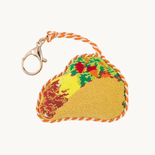 Needlepoint taco bag charm in yellow, orange, and green with orange and white rope trim and gold tone clasp