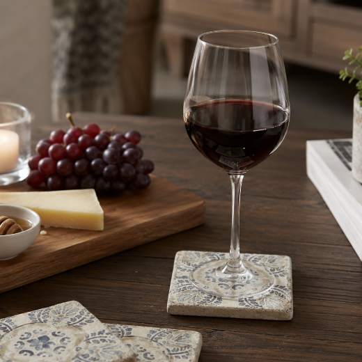 Set of four Talavera pattern Italian tumbled marble coasters arranged in a grid. 