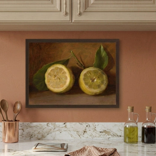 Framed vintage style oil painting reproduction of two sliced lemons with leaves against a rich, dark amber background in a classic thin gold frame.