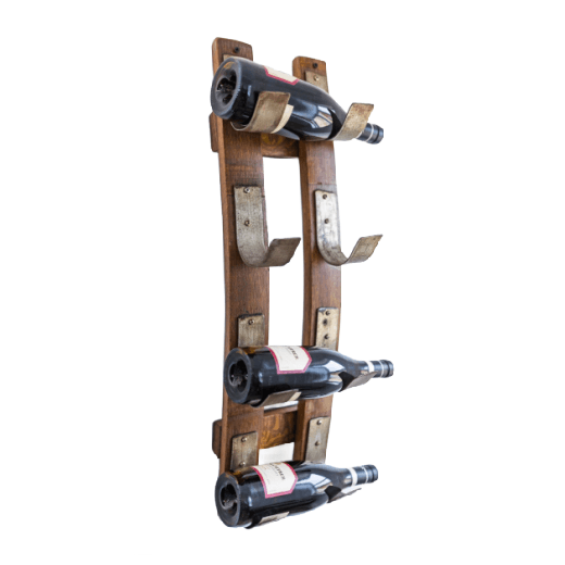Man holding a bottle of wine next to a wall-mounted wine stave wine rack in a bar setting.