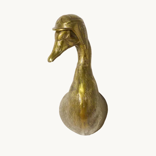 Antique brass finished duck bust wall mount wearing a vintage aviator cap.