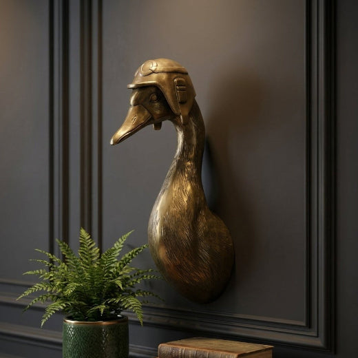 Antique brass finished duck bust wall mount wearing a vintage aviator cap.
